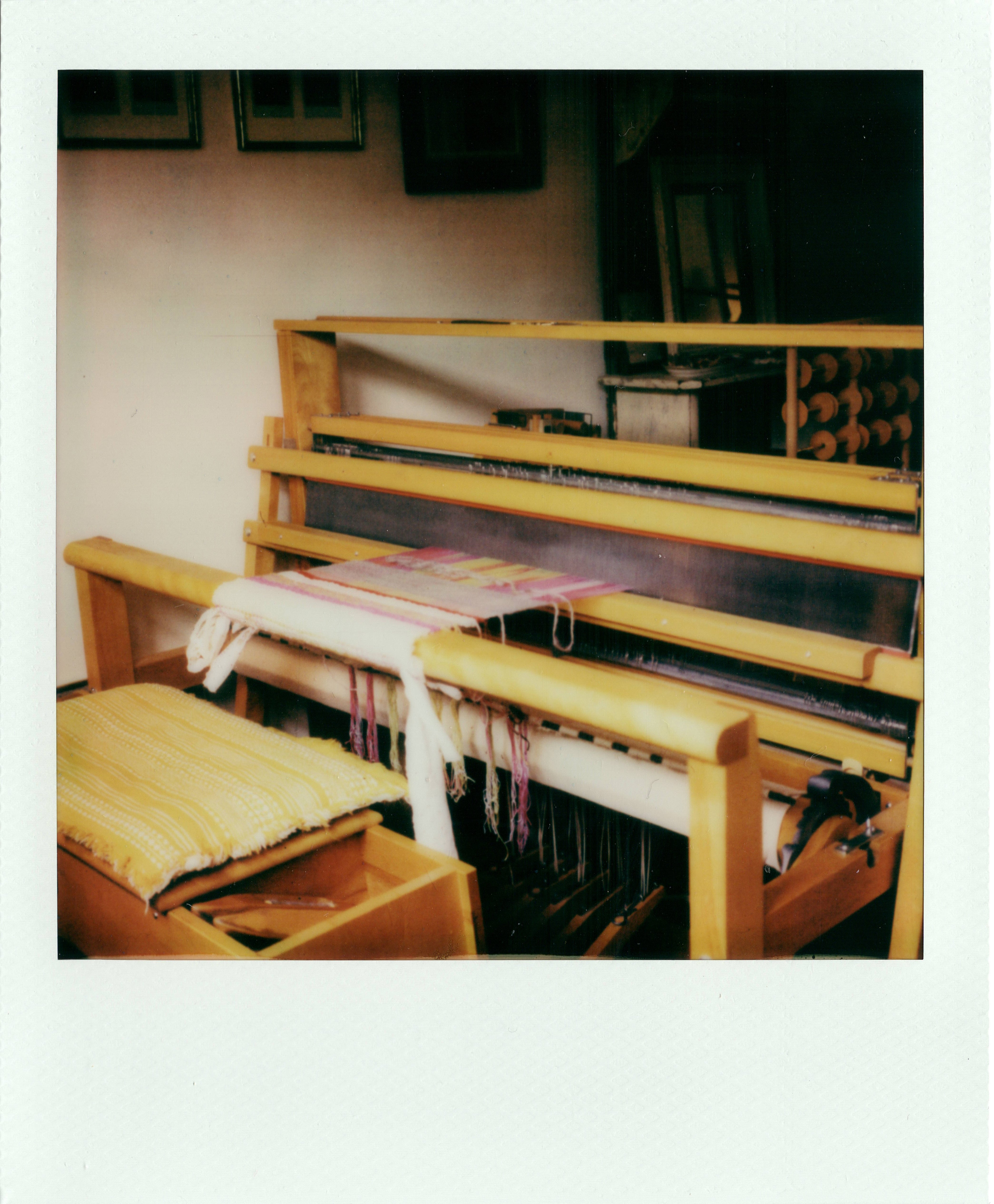 Wooden loom with fabric in a workshop setting